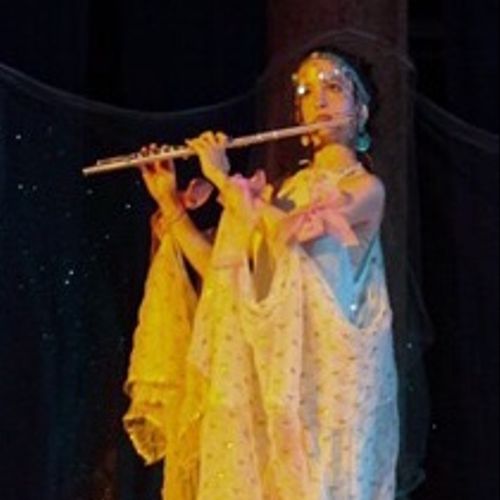 Playing flute in a performance of Shakespeare's "M