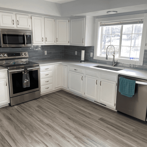 Custom blue glass tile backsplash. Flooring contin