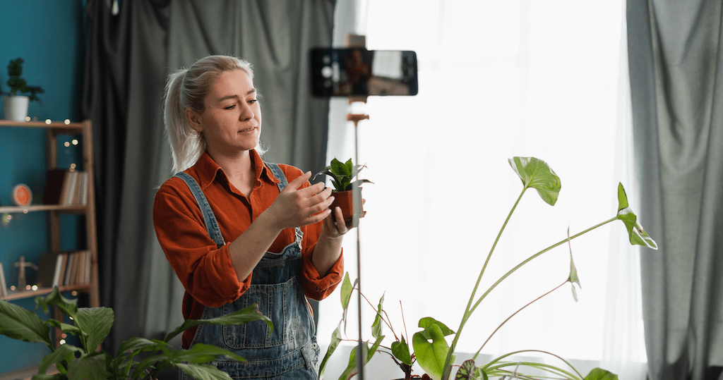 influencer filming with an indoor plant