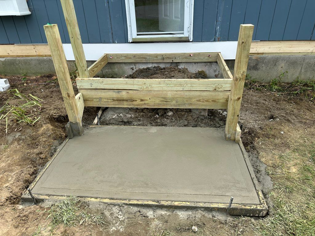 Frame and concrete pad for new stairs and landing.