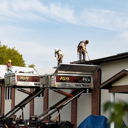 Our crews working on an asphalt roof in Reinholds,