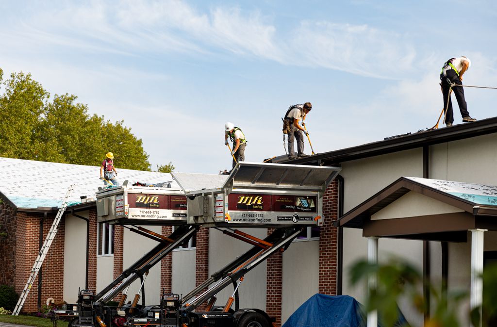 Our crews working on an asphalt roof in Reinholds,