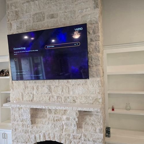 TV mounted on brick wall 