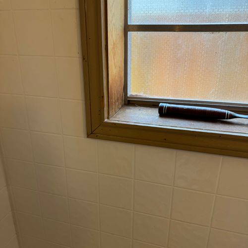 Wooden window sill and trim in shower. BEFORE