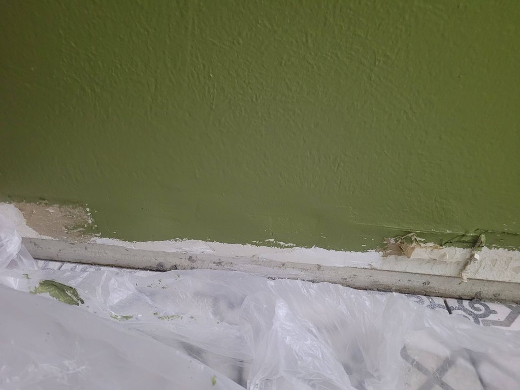 Baseboard drywall patch after final sanding and pa