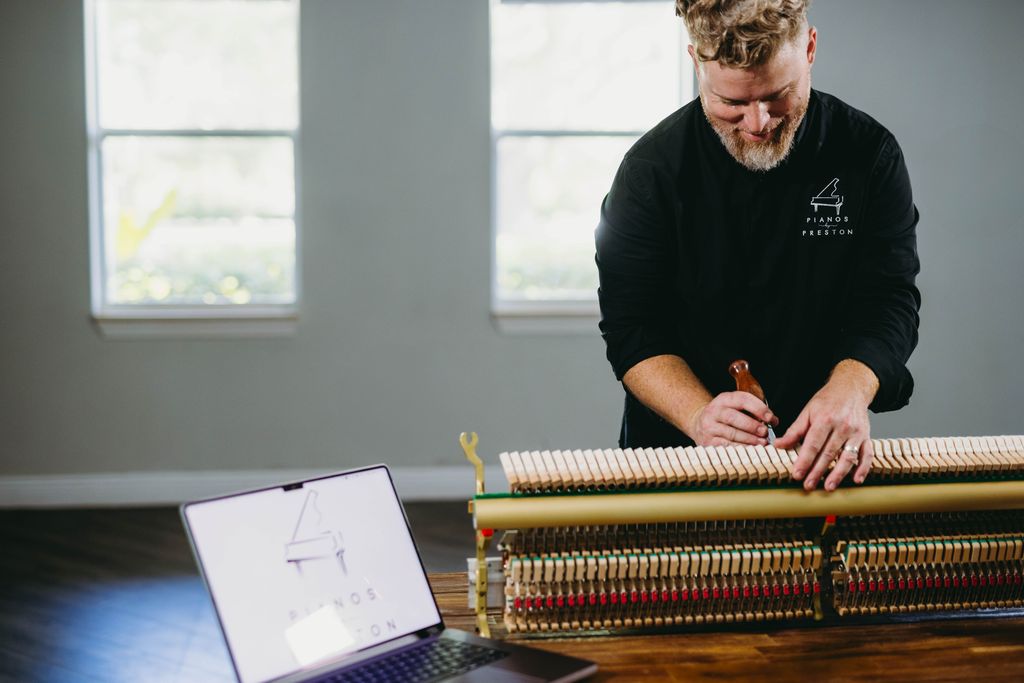 Our piano technician Timothy working on an upright