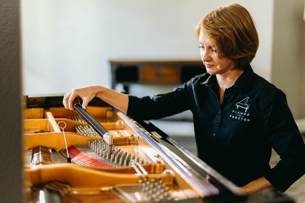 Our piano technician Rachel tuning a grand piano.