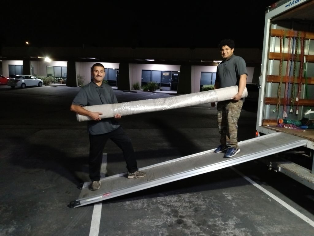 Movers bringing in items from staging job.