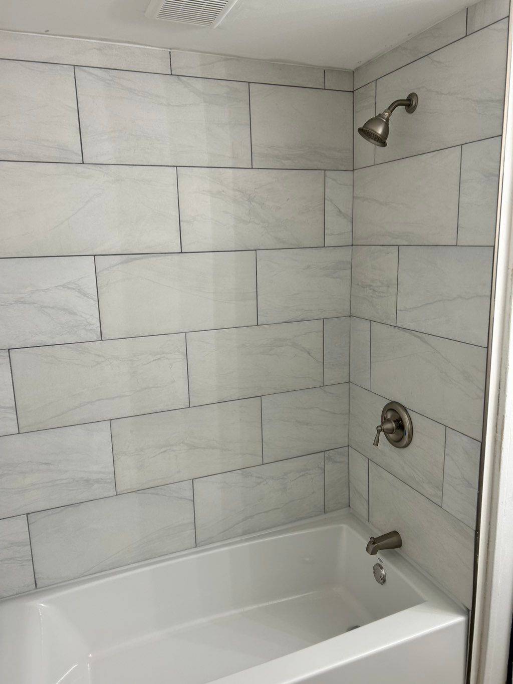 Shower tile, tub installed, fixtures, floors, vani
