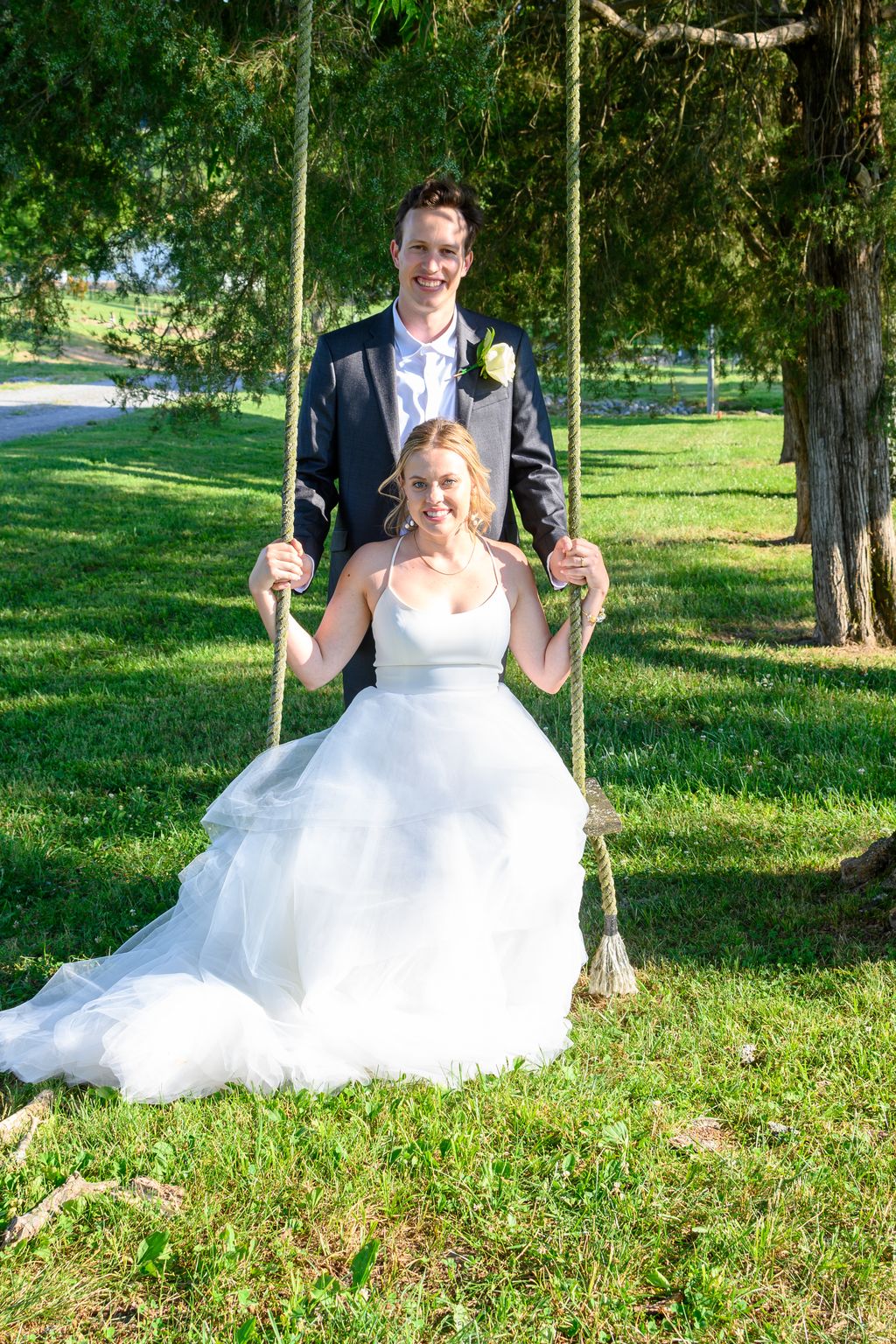 Groom pushing bride on swing at Magnolia Farm Eagl