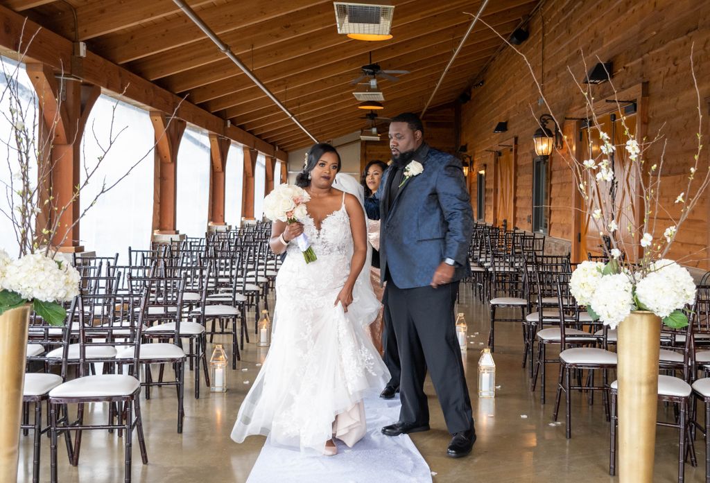 Bride and groom posing for photos at The Barn at S