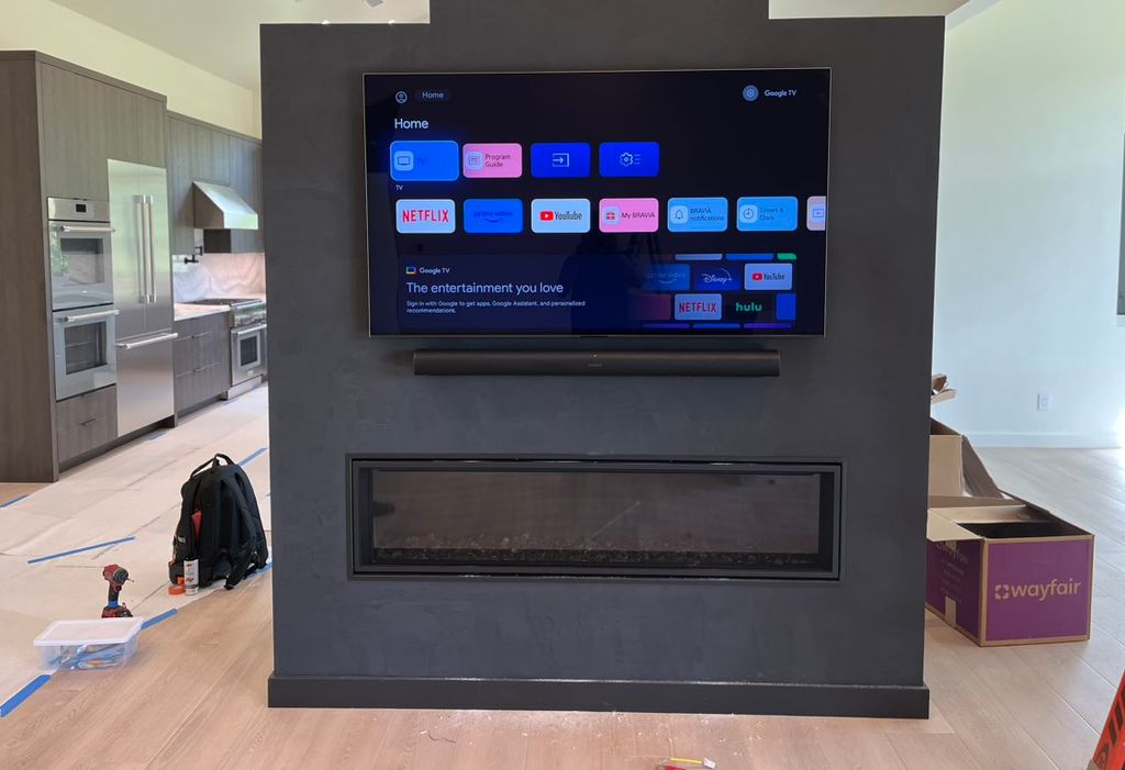 TV and soundbar install over fireplace