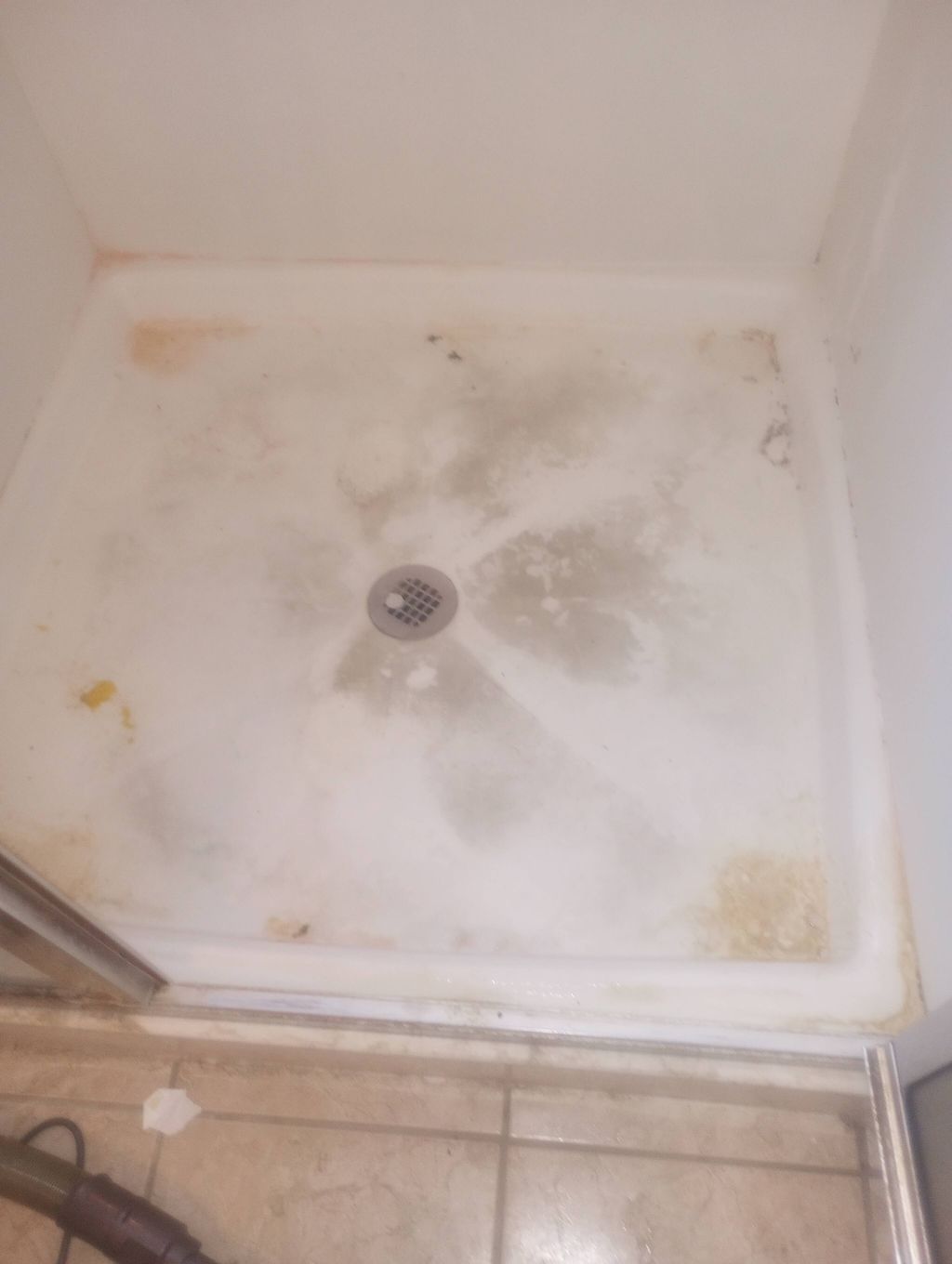 BEFORE (soap scum buildup shower floor)