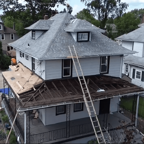 Two story shingle job in process