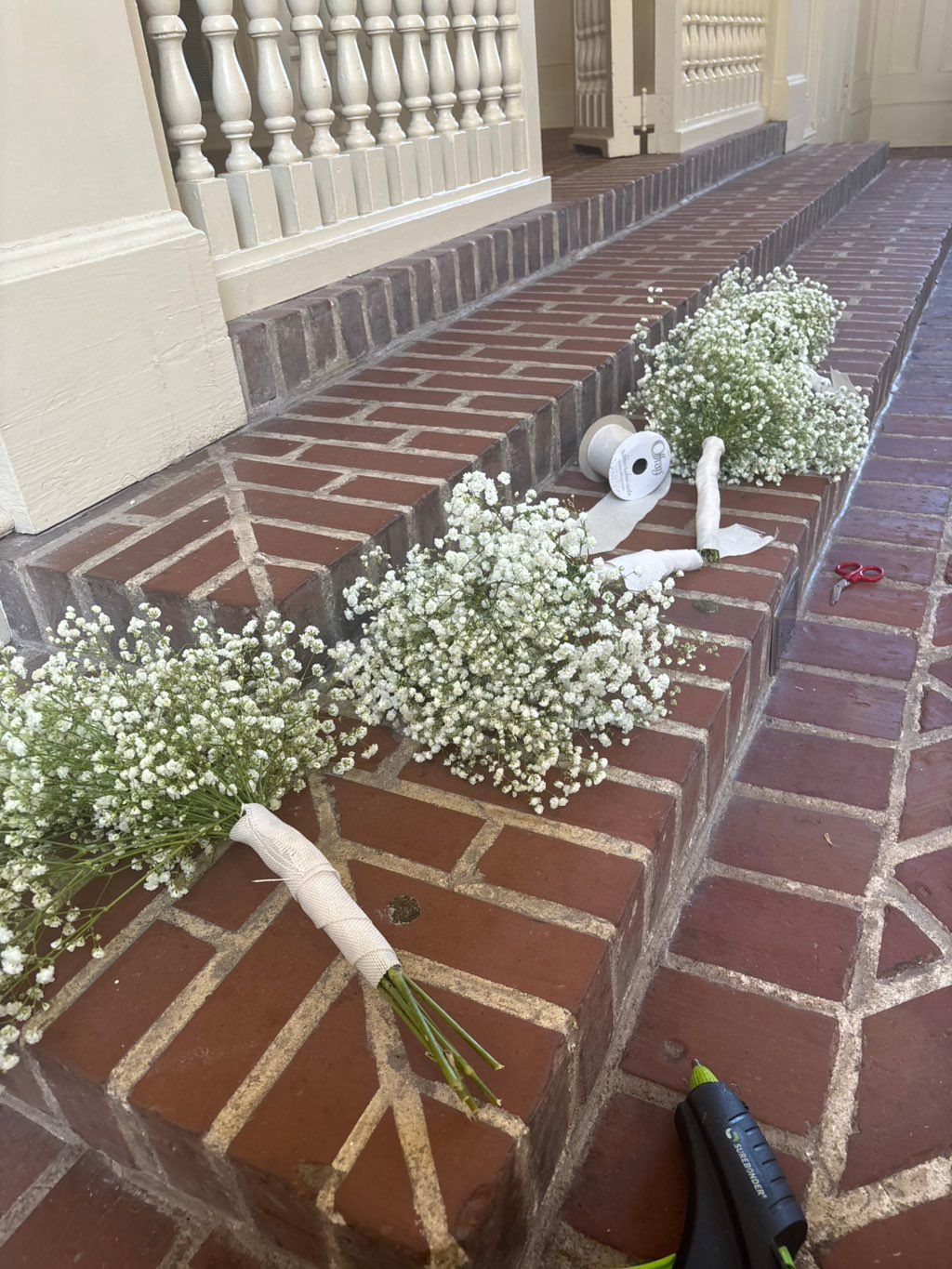 Putting all the bouquets together for bridal party