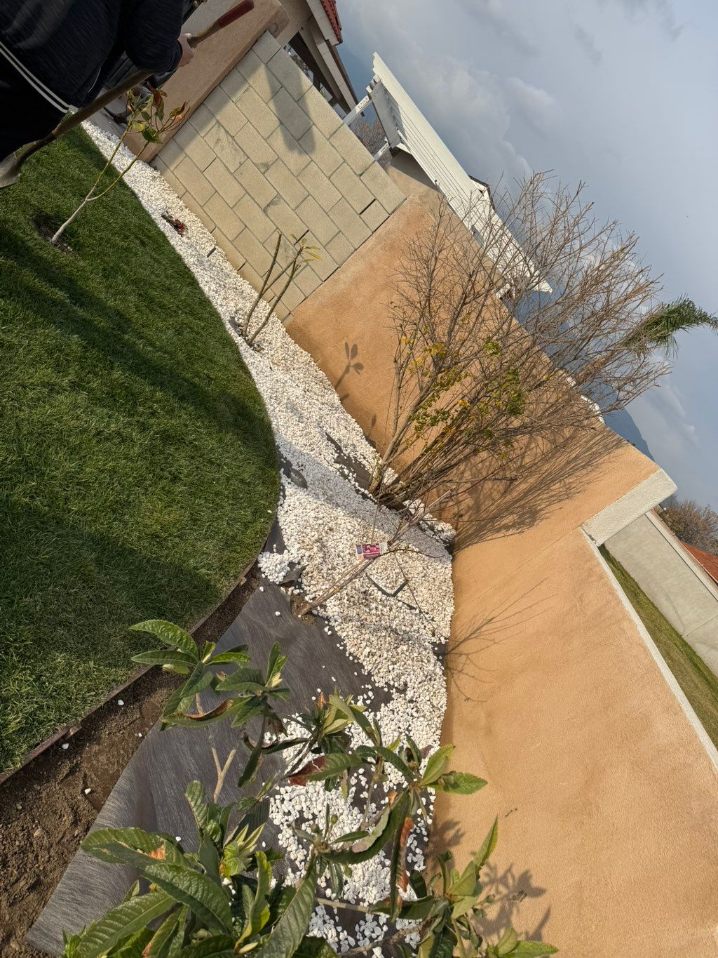 Rock and weed barrier installation in process