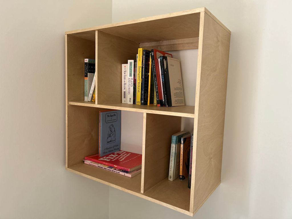 Custom bookcase with wax finish attached to wall w