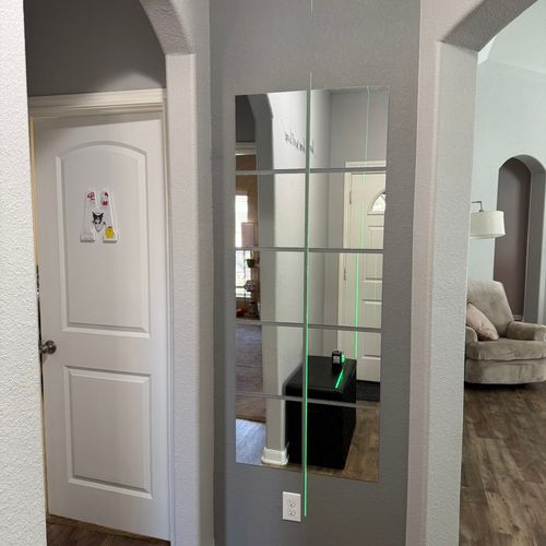 Installation of a mirror in the entryway.