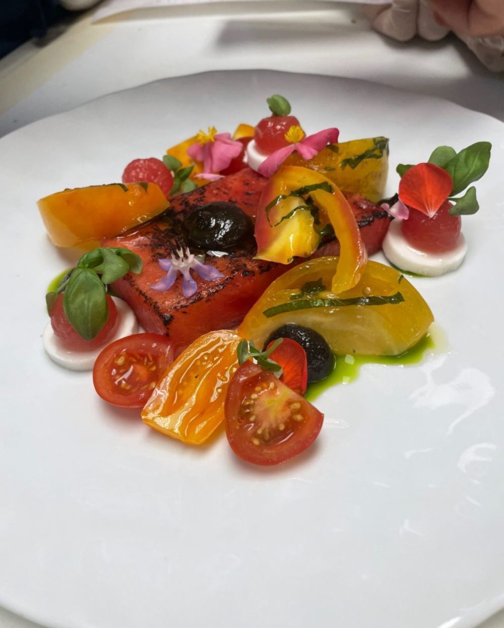 Grilled watermelon salad, tomato conserva,goat che