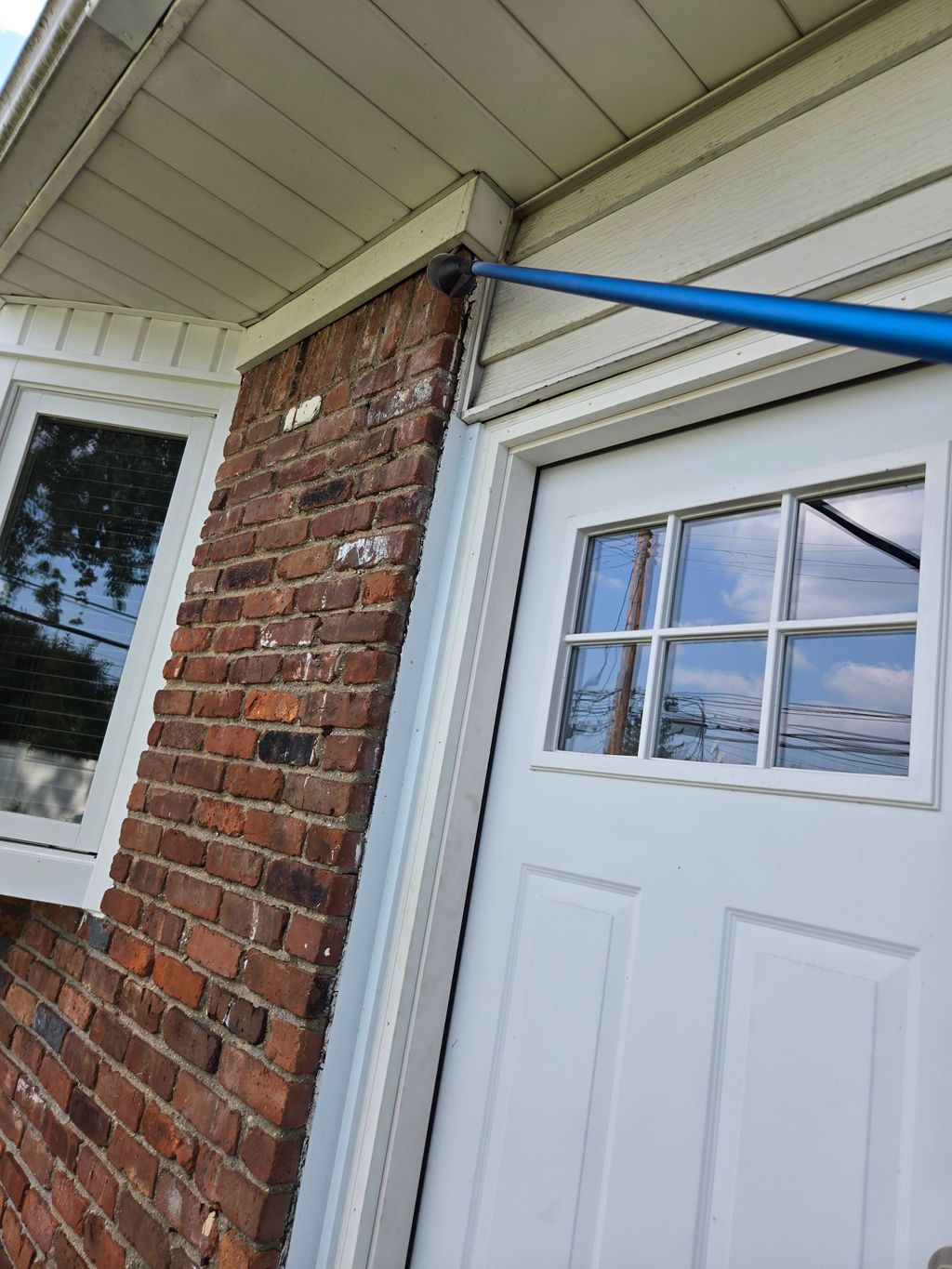 wiping down soffit area for spiderwebs