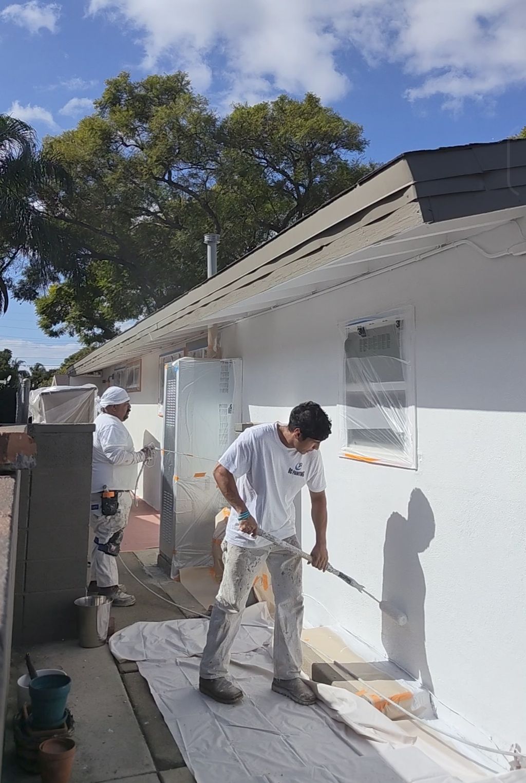 Painting and backrolling for a smooth stucco finis