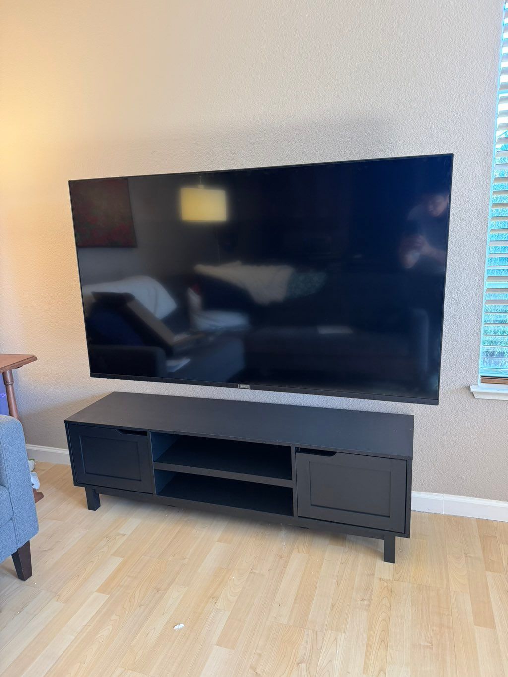 65” TV installed to the wall and assembled TV stan