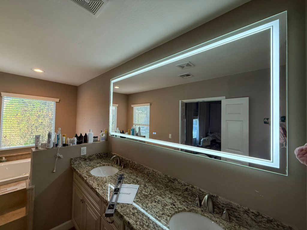 Installation of lighted fog fog resistant mirror.