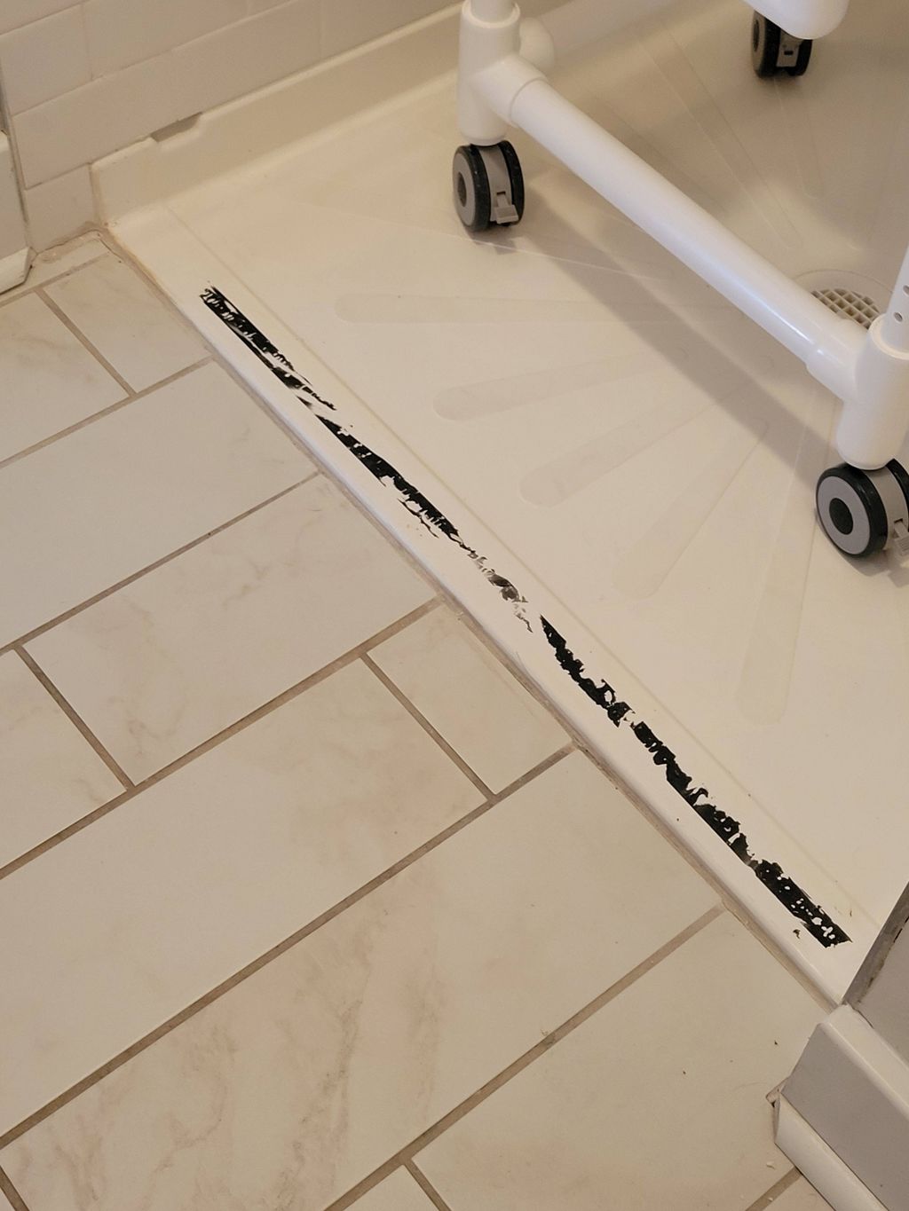 The curb on this walk-in shower, which previously 