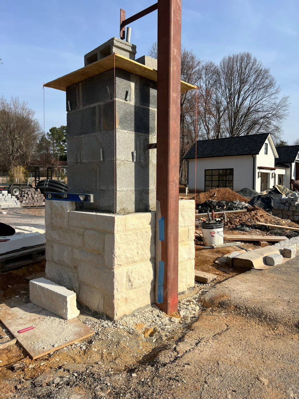 Built column and faced with stone. 