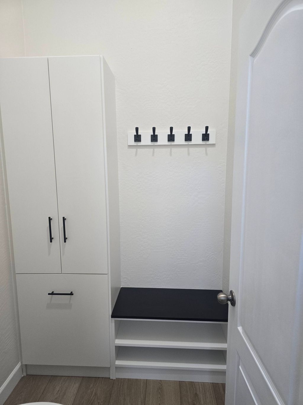 Custom bathroom storage with towel hooks.