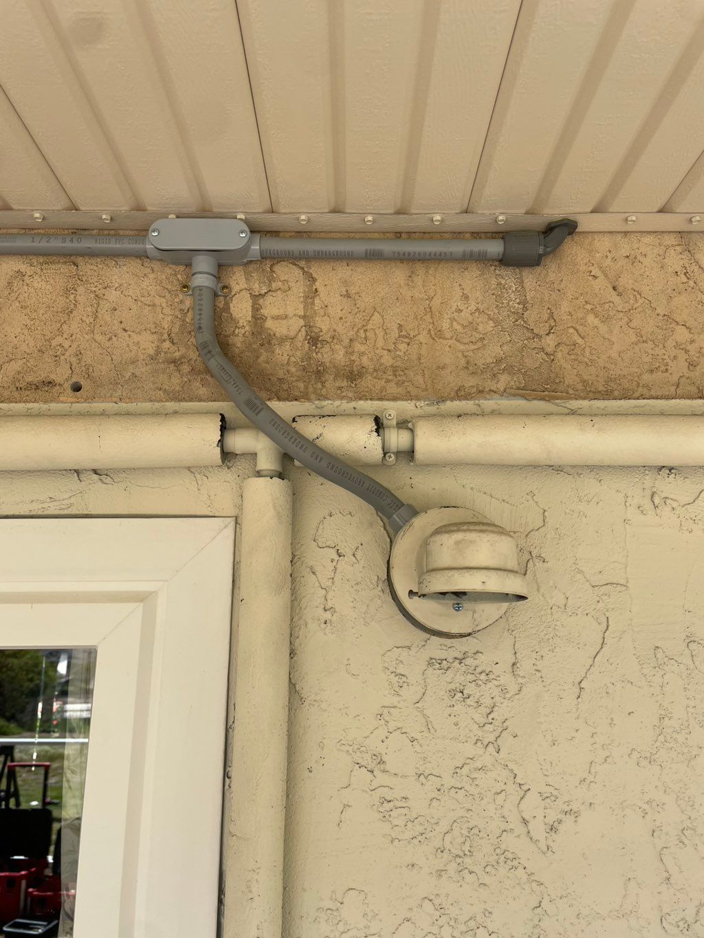 Custom conduit bend around the exterior hot water 