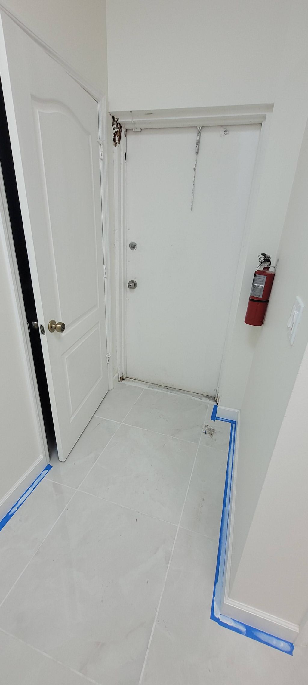 Entrance to bathroom with new tile, freshly painte