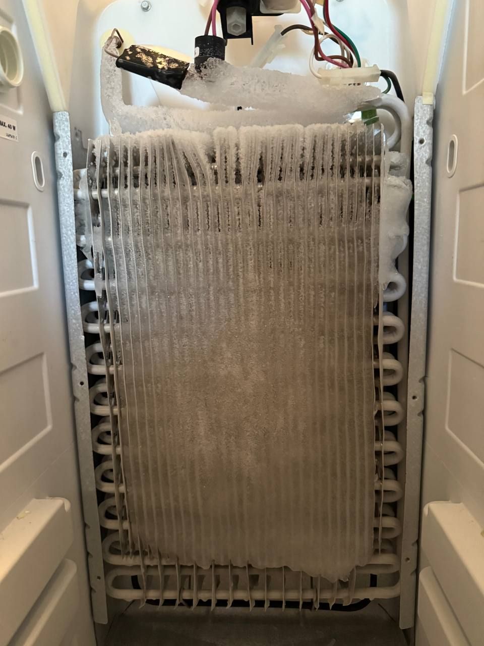 Fully frosted evaporator coils in fridge