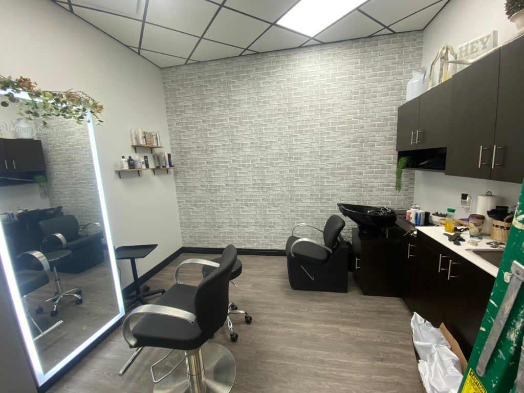 Brick wall paper installed in this salon suite to 