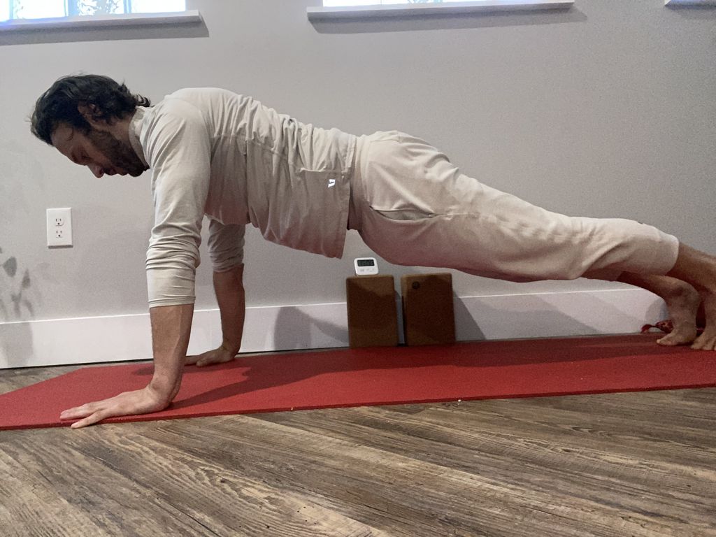Demonstrating a strong plank pose for a 70 year ol
