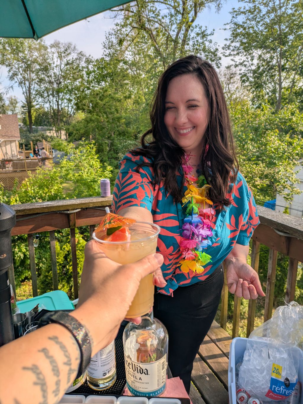 Serving a signature Pink Shirt Punch cocktail at a