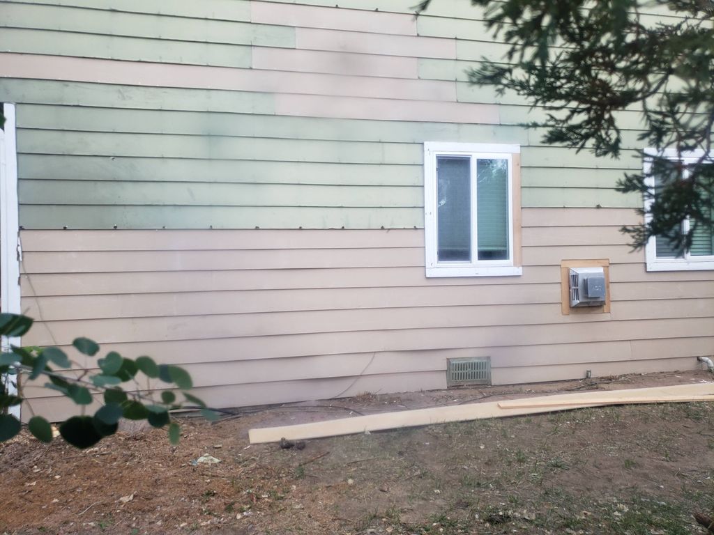 Removing bad siding and replacing it with new sign