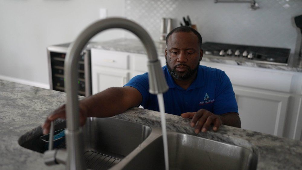 One of our technicians checking the kitchen faucet