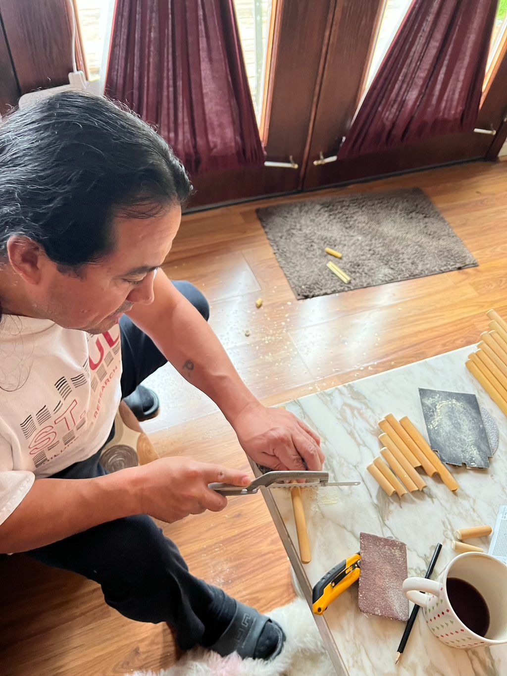 Patricio at work making a panpipe