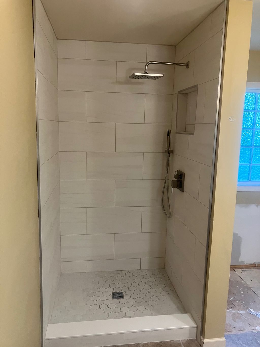 demoed old fiber glass shower, moved plumbing and 