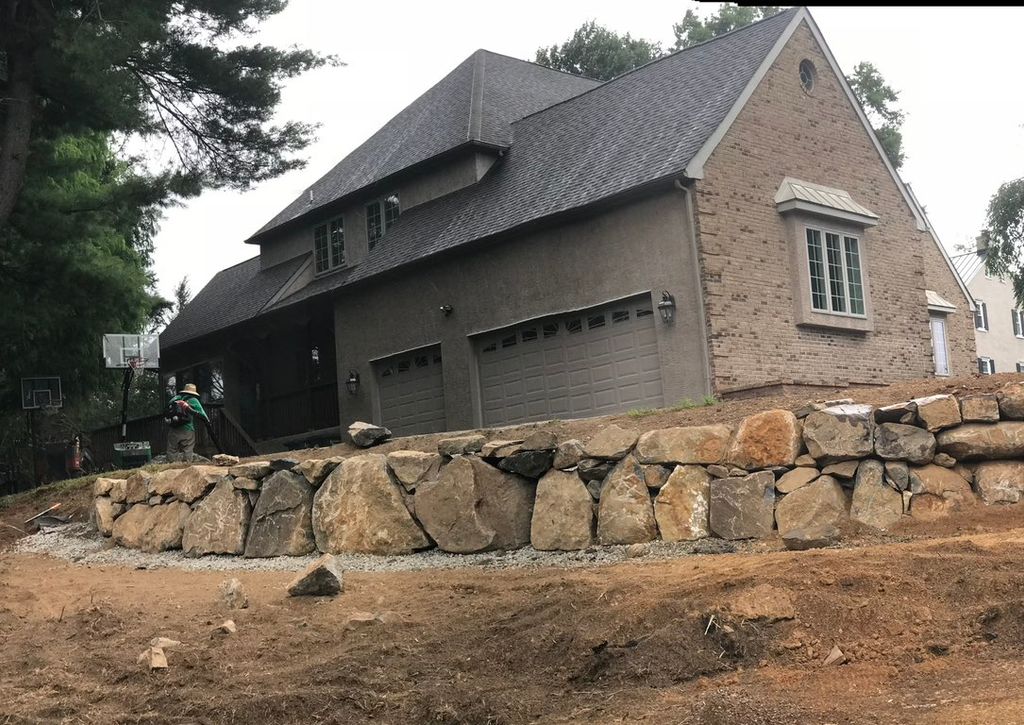 Retaining boulder wall & to raise ground to create