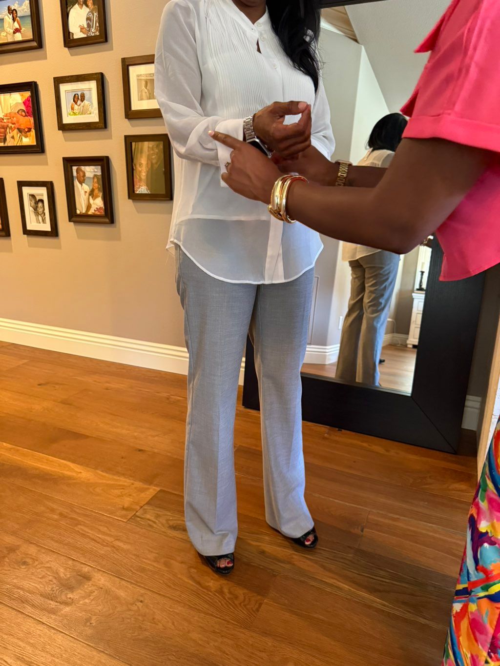 Assisting client with trying on her outfit 