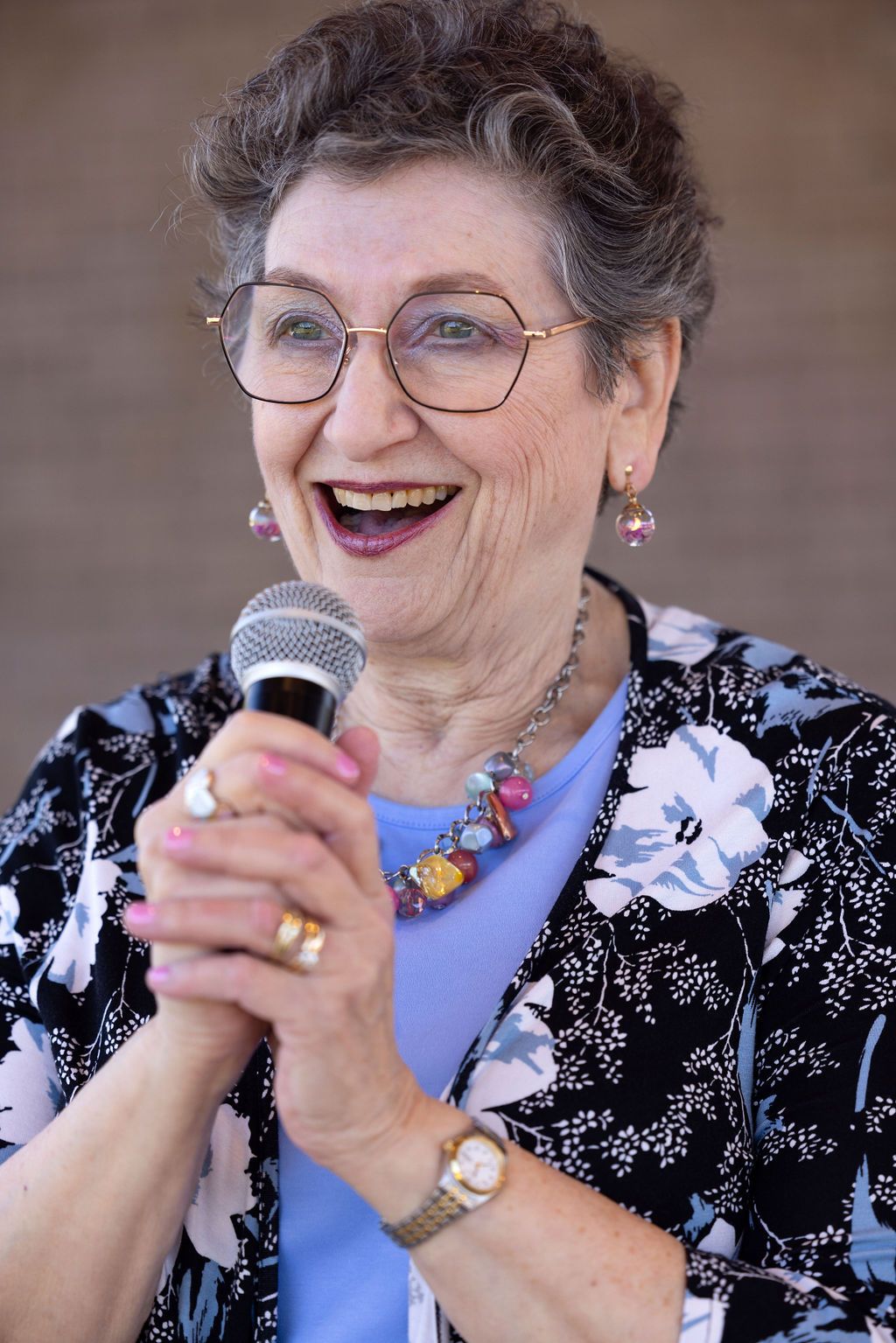 Paula with handheld mic.