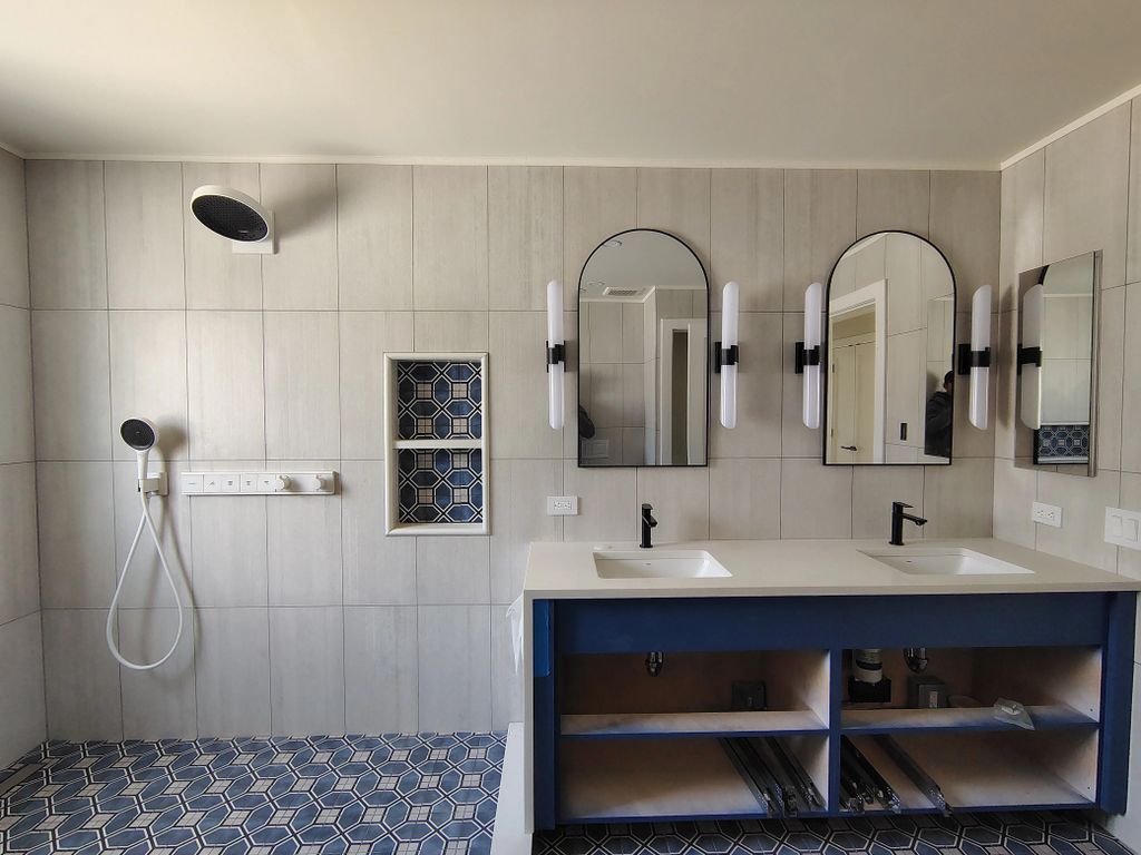 INSTALLATION OF PLUMBING, CABINETS AND MIRRORS