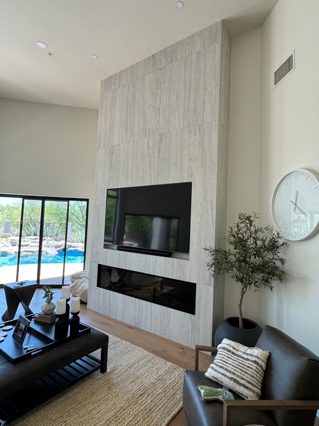 TV is mounted to sit flush with the tile. 1/2” gap