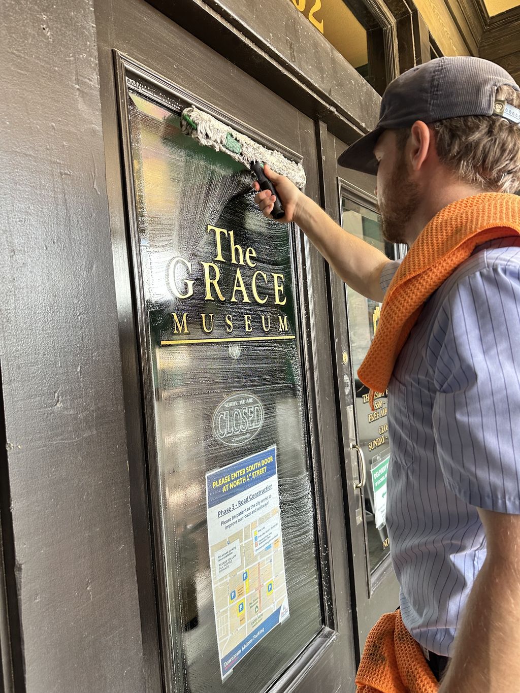 Cleaning the windows of the Grace Museum