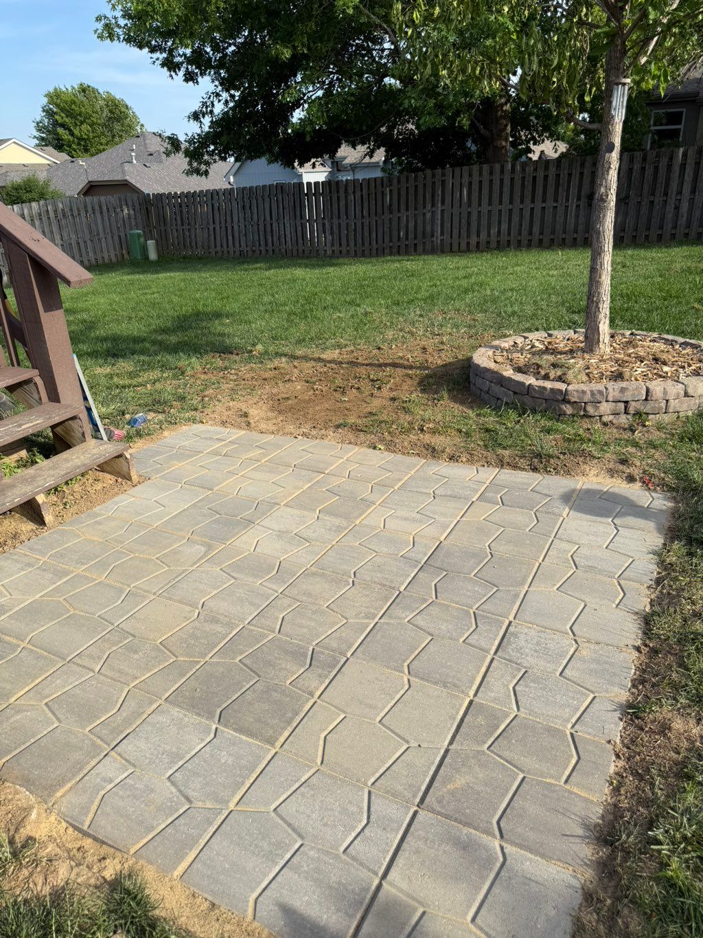 Set 26 16x16 pavers to match existing landscaping 