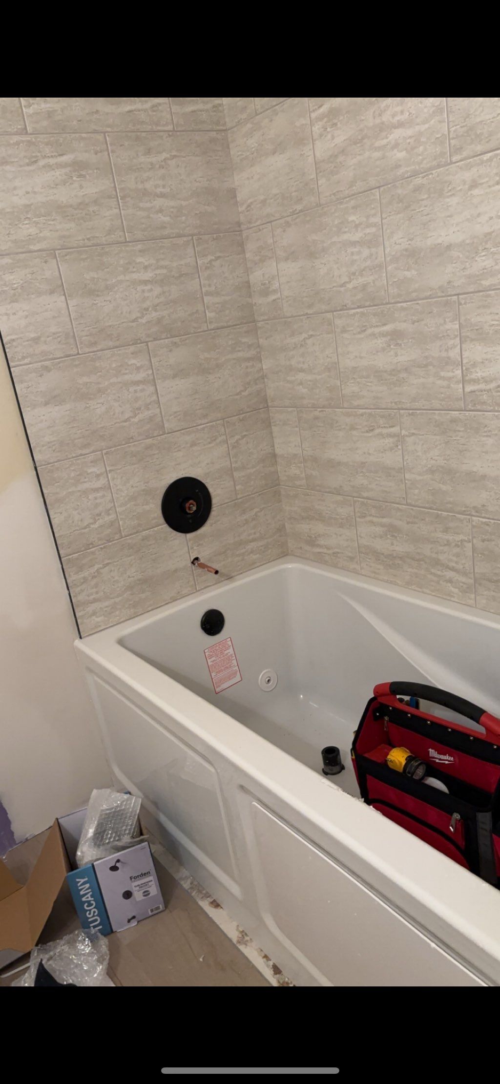 Installed bathtub and plumbing fixtures