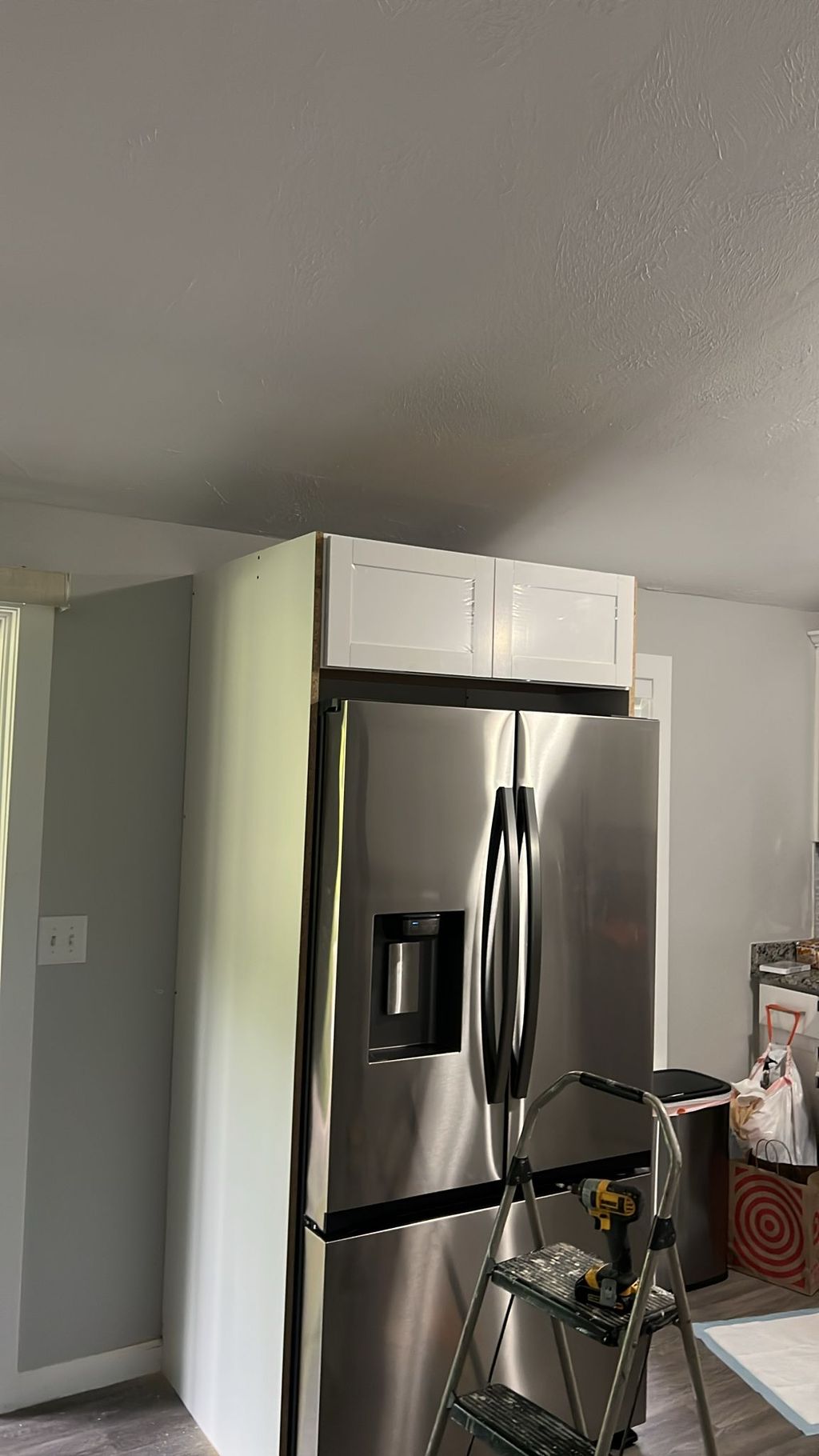 Building cabinet above fridge