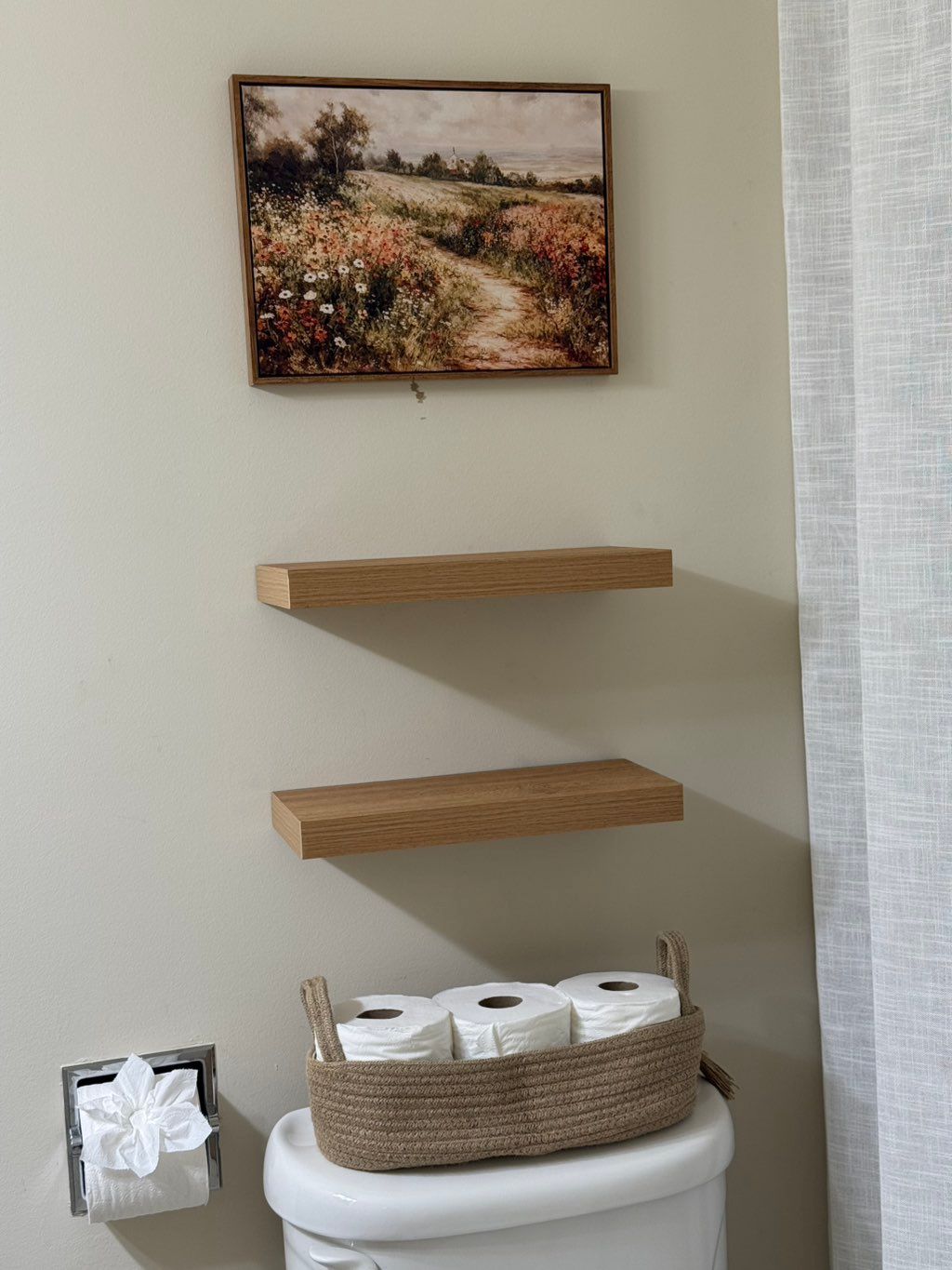 Two bathroom shelves and artwork mounted